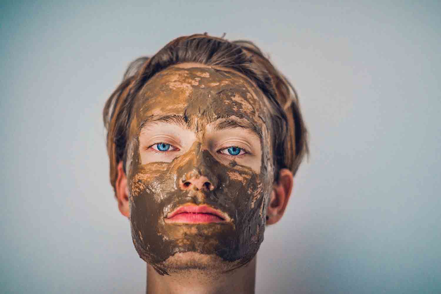 man with mud mask applied