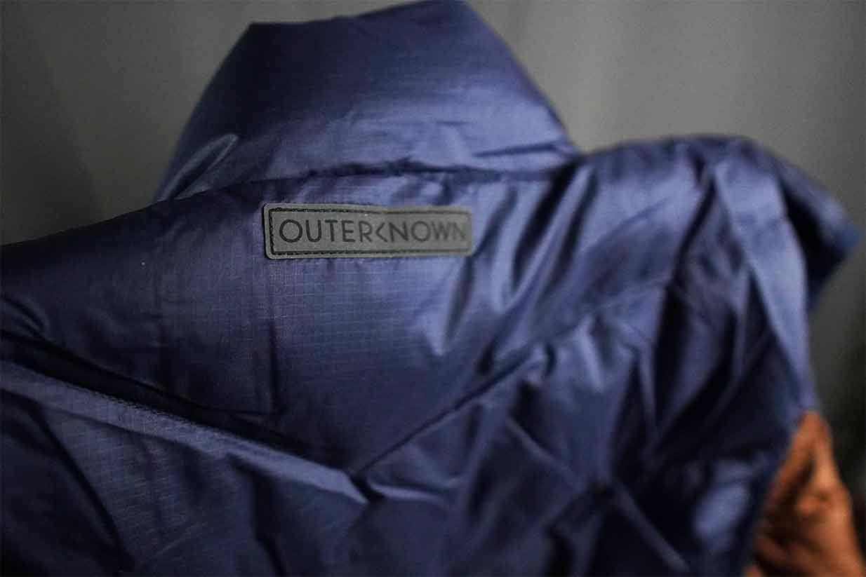 outerknown summit puffer vest back tag details